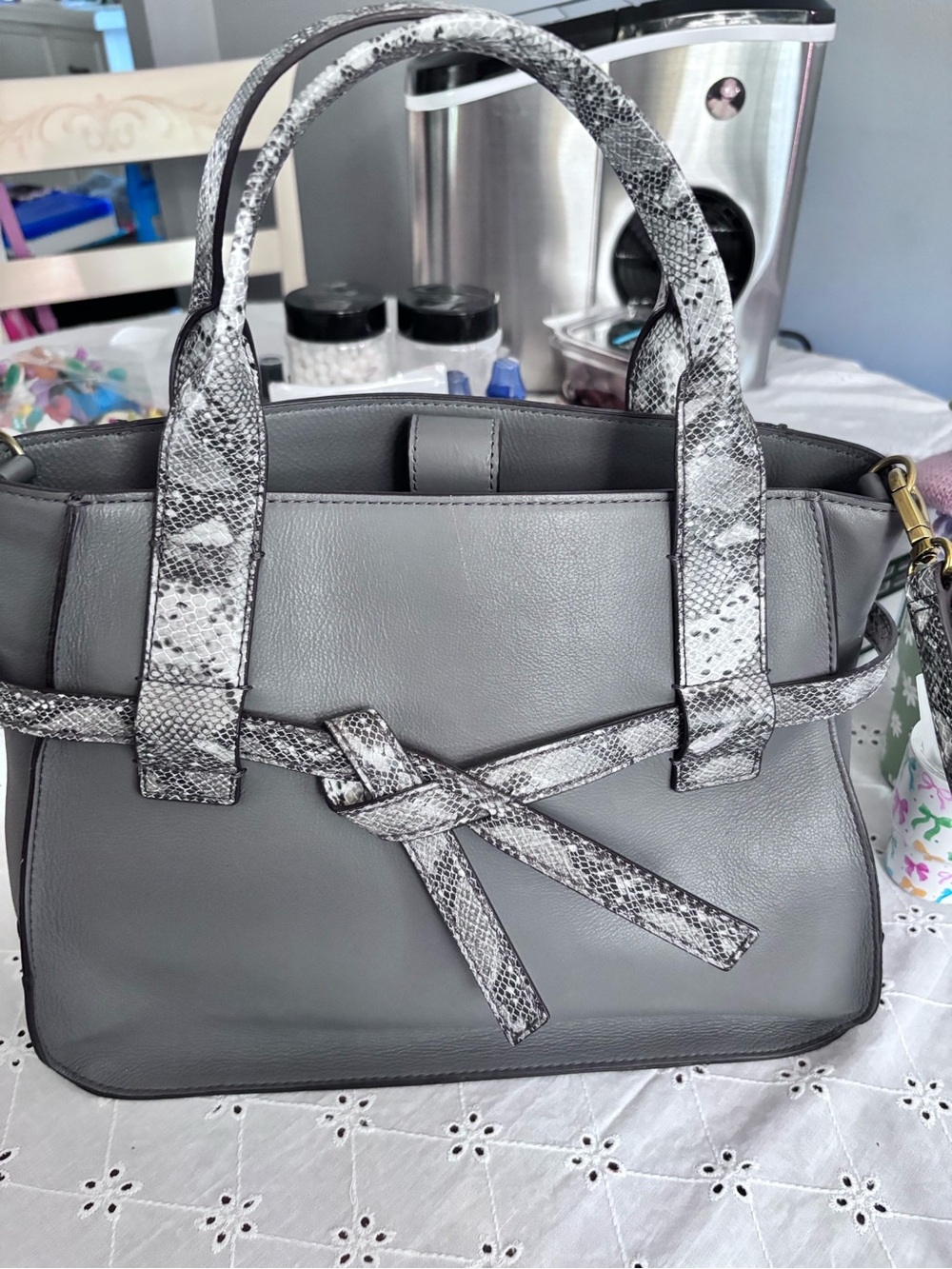 Fossil Willow satchel in gray leather, highlighted by a distinctive snake-print